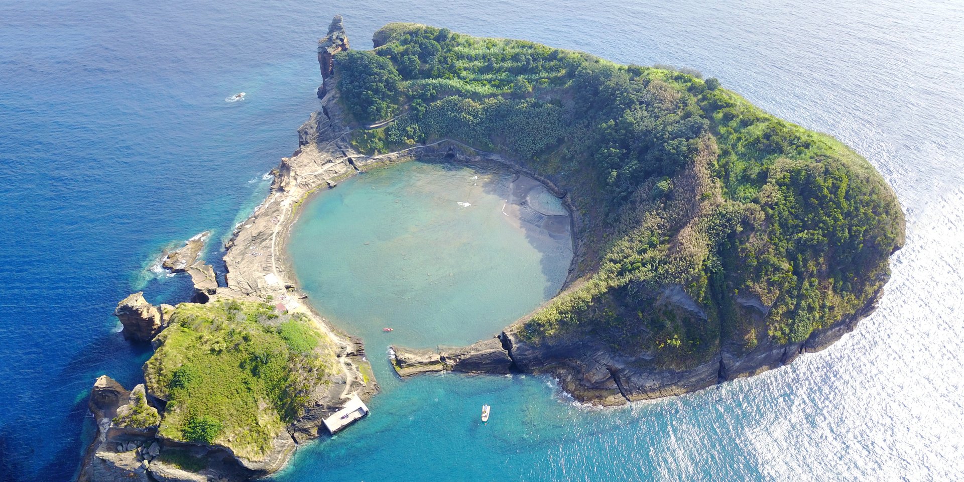 Aerial view of Vila Franca do Campo islet in the Azores featuring a circular volcanic crater lagoon.