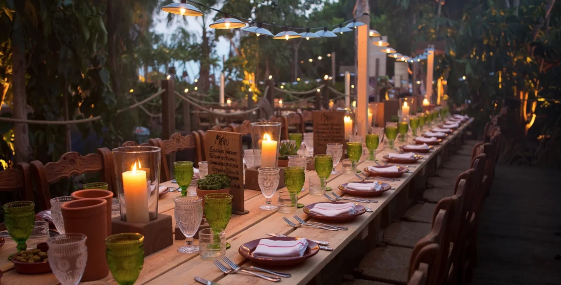 Long candlelit wedding banquet table in Marbella garden