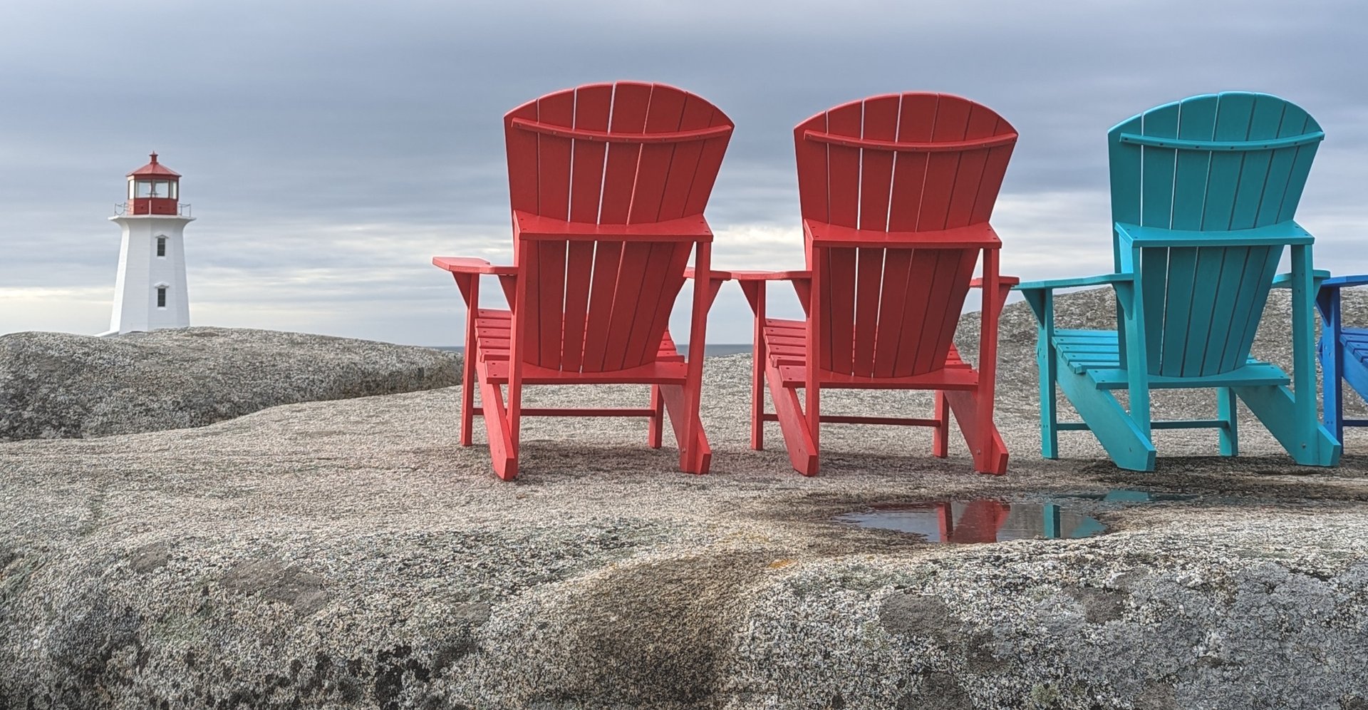 image of three adirondack chairs on rocks