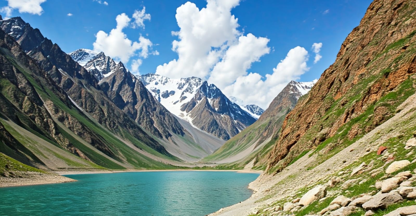 a mountain scene with a lake and mountains in the background