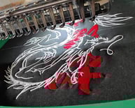 a machine embroiderying a picture of a embroidery machine