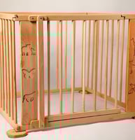 a wooden baby gated in a wooden fenced in area