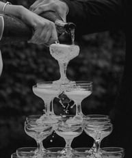 a man and woman are pouring champagne into glasses