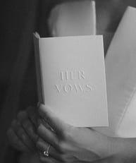 a woman holding a book with her hands in her hands