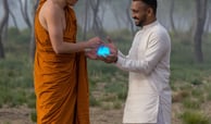 monk and blue stone in the field feeling happy