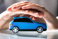 a person holding a toy car in their hands