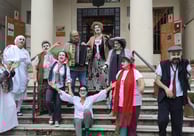 a group of people dressed in costumes for halloween