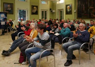 a group of people sitting in chairs in a room