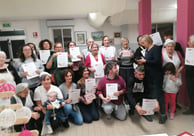 a group of people holding up certificates and holding up certificates