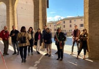 a group of people standing in a line of arches