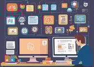 man in gray dress shirt sitting on chair in front of computer monitor