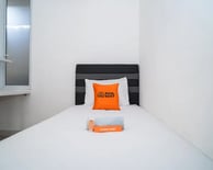 flazale reddoorz flash sale a bed with a pillow and a pillow on top of it