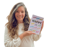 smiling woman with long brown hair and white sweater holding a book