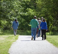 Photo of people walking on a paved path