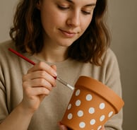 woman at hen party paint a plant pot with polka dots