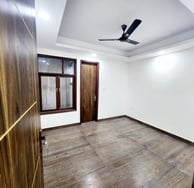 Spacious Bedroom of 3 BHK Builder Floor Near Sky Mansion Chattarpur with false ceiling and window