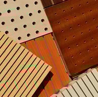 Wood perforated acoustic panels installed for sound control and design enhancement.