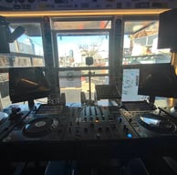 a dj booth at The Lot Radio -NYC, with a laptop and a laptop