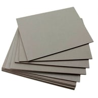 a stack of flat paper boards