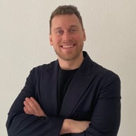 a man in a suit and tie smiling