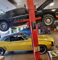 a car is parked in a garage with a lifter