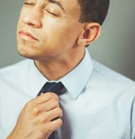 a man in a blue shirt and tie tie