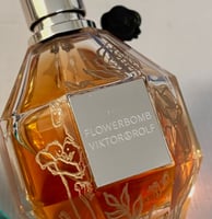 bottle of Flowerbomb perfume with hand engraved flowers that are filled with gold