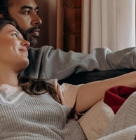 a man and woman sitting on a couch
