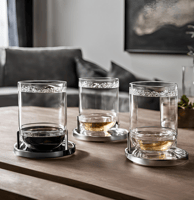 three glasses of whiskey on a table