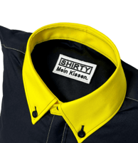 a black shirted pillow with a yellow collar and label