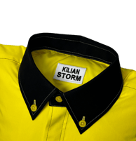 a yellow shirted pillow with a black collar and label