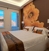 a bedroom with a large bed and a television