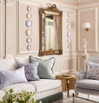 a living room with a couch and a mirror