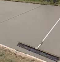 a sidewalk of concrete that is being leveled and formed