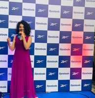 woman holding mike in an event