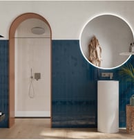 a bathroom with a round mirror and a round mirror