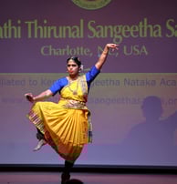 a woman in a yellow dress is performing a dance