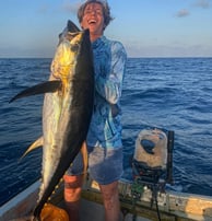 Fisherman holding a large Yellowfin Tuna during a Full-Day Fishing Charter in Zanzibar