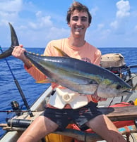 Happy client with a yellowfin tuna on a Zanzibar Catamaran Fishing Charter