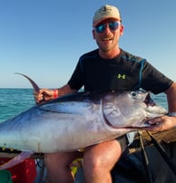  client with a tuna on a Zanzibar Catamaran Fishing Charter