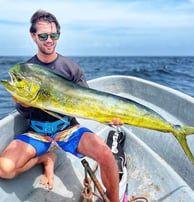 Fisherman showing off a vibrant dorado caught on a Half-Day Fishing Charter in Zanzibar