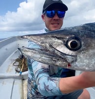 Thrilled angler with a King Fish caught on a Full-Day Fishing Charter in Zanzibar