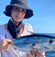 Girl proudly showing her caught fish on a catamaran - Catamaran Fishing Charters Seychelles