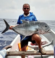 Angler holding a giant trevally on a Catamaran Fishing Charter in Zanzibar