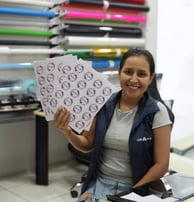 a woman holding a piece of paper with a picture of a woman holding a piece