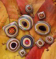 a selection of bright orange jeep fordite cabochons
