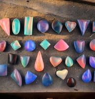 colourful selection of opal cabochons with lots of opal flash