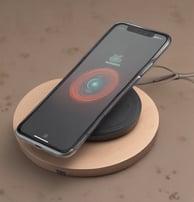 A sleek smartphone with a metallic finish stands upright on a table alongside a modern smartwatch, wireless earbuds, and a glowing antique-style bulb. The scene is set against a dark background, emphasizing the shiny surfaces and elegant technology.