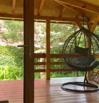 a hammock chair in a room with a chair and a chair