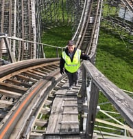 a female inspector on a wooden roller coaster